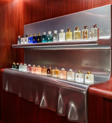 Amouage perfume collection displayed on shelves.