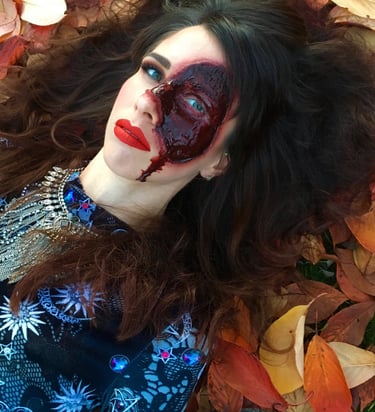 a woman with a bloody face created with special effects makeup