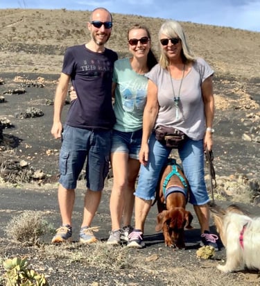 a man and woman standing in front of a mountain