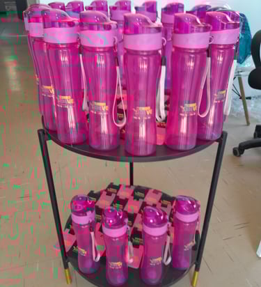a carton of pink plastic cups and bottles of water branded sibeve
