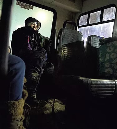 A bundled up woman on an emergency cold-weather shuttle.