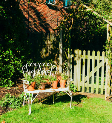 Idyllic garden scenery with flowers and a bench