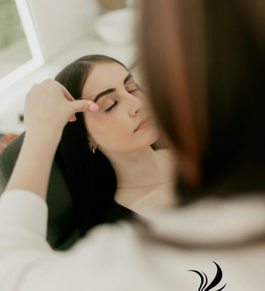 a woman is shown in a mirror while she is getting her hair done