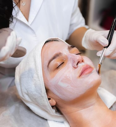 a woman getting a facial mask with a facial mask