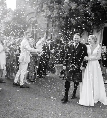 Isabella and Doug having a confetti moment outside Morden Park House