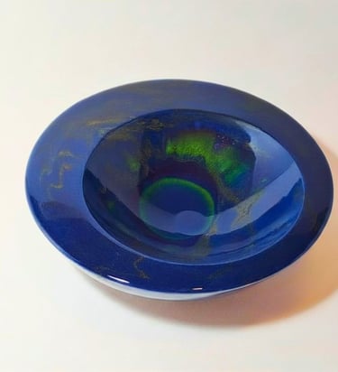 Handmade deep blue gypsum decorative bowl with iridescent northern lights green swirling effects.
