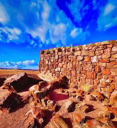 Ancient Agate House ruins built from petrified wood at Petrified Forest National Park under a bright blue sky.