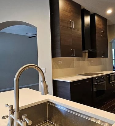 Kitchen remodel with a sink, modern cabinets, and built-in appliances.