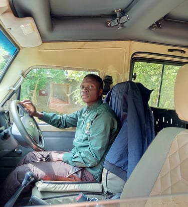 Professional Isra Safaris guide driving a custom safari vehicle during a Murchison Falls National Pa