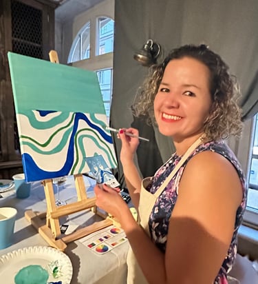 Une fille qui fait une peinture et qui participent à une soirée paint and sip , apéro peinture