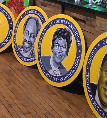 Images of scientists and inventors painted on board for a school mural installation.