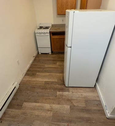 Crew removing old refrigerator during appliance removal service