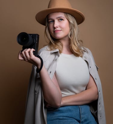 a woman in a hat and a hat with a camera