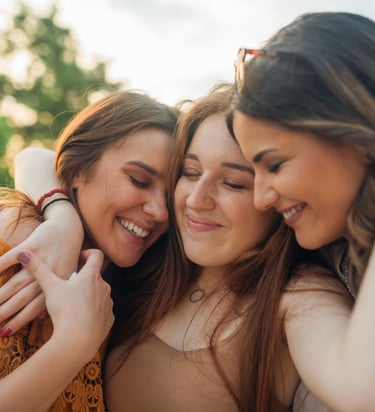 three girls are hugging their arms around each other