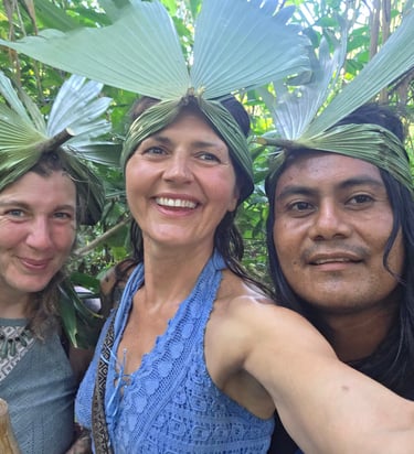 three people standing in front of a forest with jungle crowns