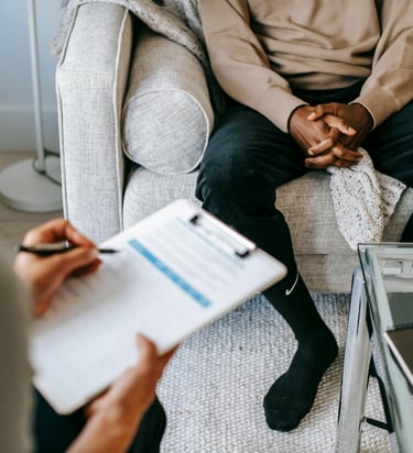 man sits on sofa in a consultation