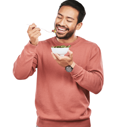 A guy eating a salad