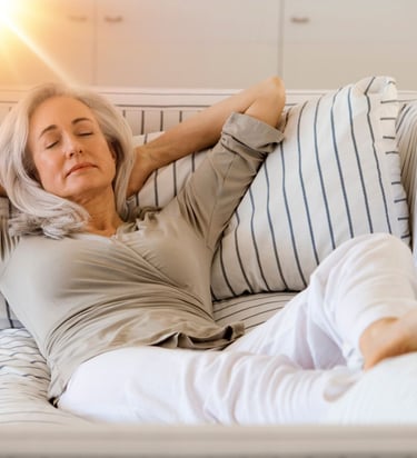 a woman is laying on a couch with her eyes closed