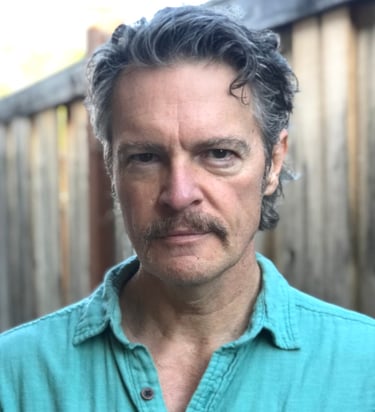 Headshot image of Todd Long with moustache