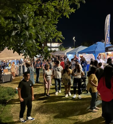 Community crowds filter through artisan booths