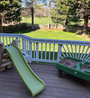 Outdoor backyard with a slide and sand box