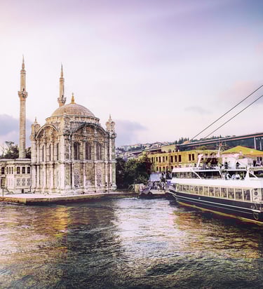 Ortaköy Mosque and a boat on the Bosphorus with the Bosphorus Bridge in Istanbul.