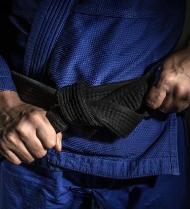 BJJ black belt on blue kimono