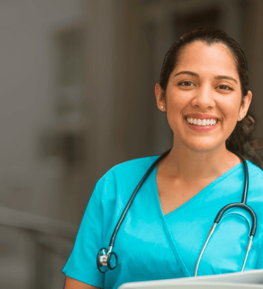 a nurse in blue scrubs with a stethoscope