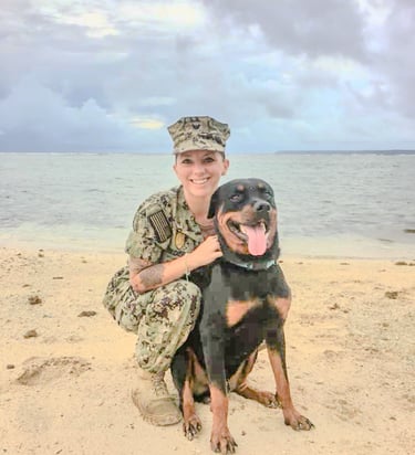 a woman in uniform is holding a dog