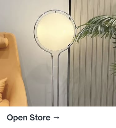 Modern sculptural chrome floor lamp in a minimalist living room interior