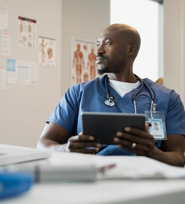 Pensive doctor with digital tablet in clinic office