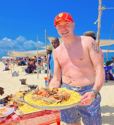 Fresh seafood lunch served on a sandbank during Safari Blue Zanzibar tour, including lobster, fish, and tropical fruits