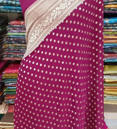 Maroon georgette saree showcasing fine floral threadwork and a lace-trimmed border