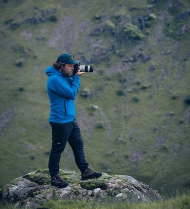 a photo of mike brogden taking photos on a mountain