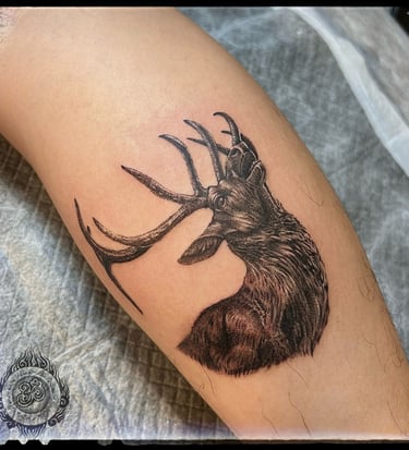 Realistic tattoo of a healthy elk on the forearm