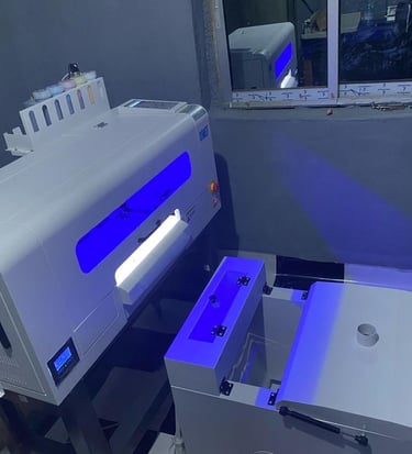 a DTF machine turned on, with bright blue lights shinning from it.