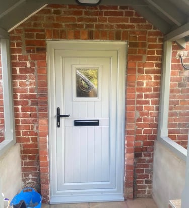 a white door with a black door and a blue bag