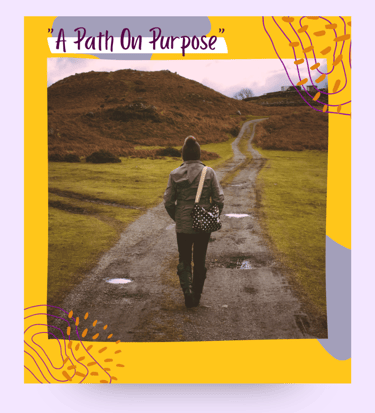 A woman standing on a path in the outdoors.