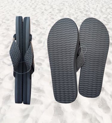 Burnsea black Onyx EVA men's thongs on a sandy beach