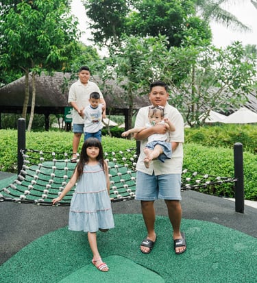 children playing in a tropical playground during a family photography session at Movenpick Jimbaran Bali