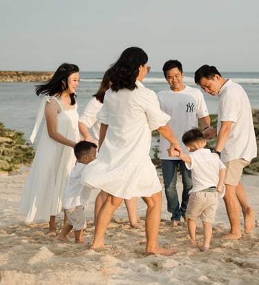 Family walking together along the beach near The Apurva Kempinski Nusa Dua Bali