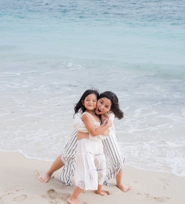 Mother hugging her children on the beach at Karma Kandara Bali  