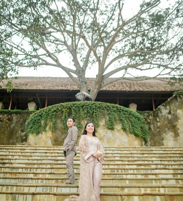 Elegant prewedding couple standing on grand staircase at Amankila Karangasem