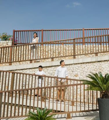 Family walking together through the resort during a natural family session at Anantara Uluwatu Bali.