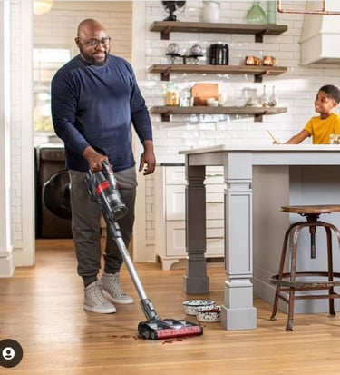 Man with a vacuum cleaning up pet food in a photoshoot