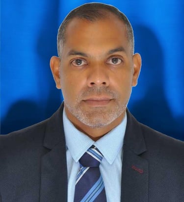 a man in a suit and tie with a blue background
