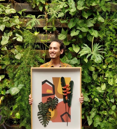 a man holding a framed print of a painting of a plant