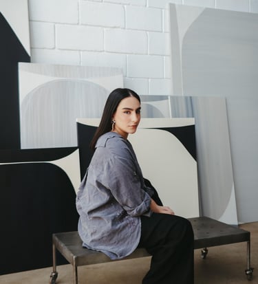 a woman sitting on a bench in a room