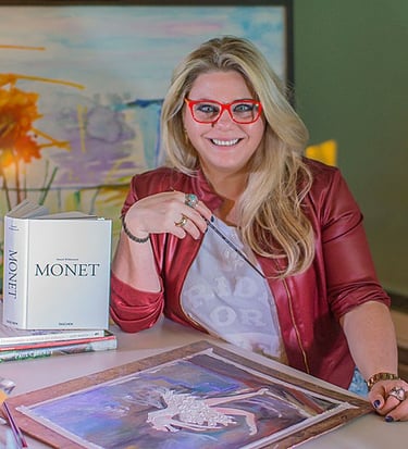 a woman sitting at a desk with a book and a book