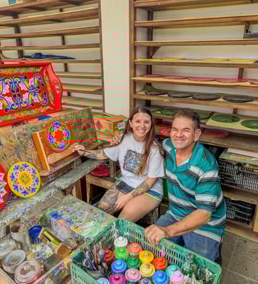 a man and woman sitting on a bench in a room